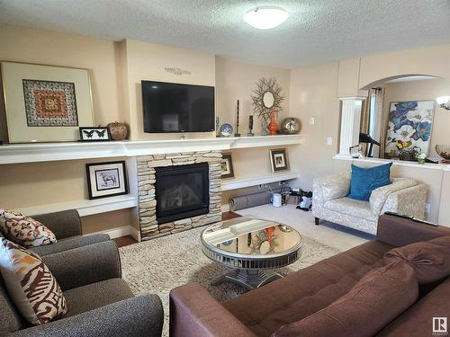 729 37A Avenue, Edmonton, AB - Indoor Photo Showing Living Room With Fireplace