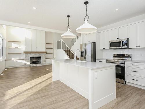 8 55101 Ste Anne Trail, Rural Lac Ste. Anne County, AB - Indoor Photo Showing Kitchen With Fireplace With Upgraded Kitchen