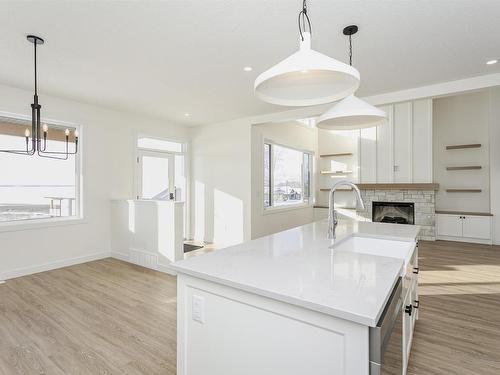 8 55101 Ste Anne Trail, Rural Lac Ste. Anne County, AB - Indoor Photo Showing Kitchen With Fireplace