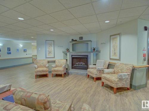 216 8802 Southfort Drive, Fort Saskatchewan, AB - Indoor Photo Showing Living Room With Fireplace