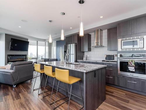 1701 11969 Jasper Avenue, Edmonton, AB - Indoor Photo Showing Kitchen With Fireplace With Stainless Steel Kitchen With Upgraded Kitchen