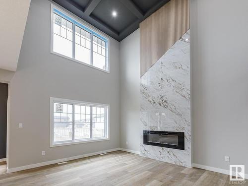 516 Merlin Landing Landing, Edmonton, AB - Indoor Photo Showing Other Room With Fireplace