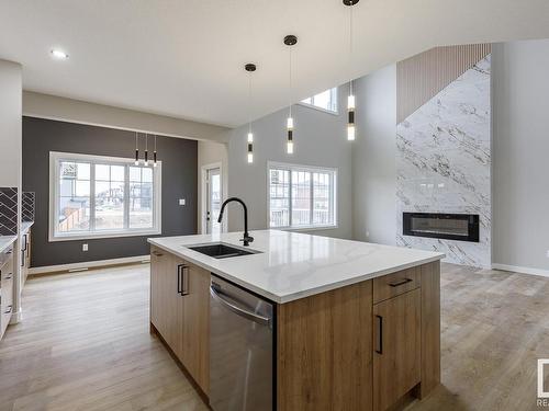 516 Merlin Landing Landing, Edmonton, AB - Indoor Photo Showing Kitchen With Fireplace