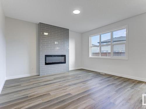 1835 Westerra Loop, Stony Plain, AB - Indoor Photo Showing Living Room With Fireplace