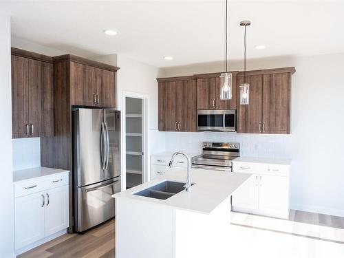 25 Waverly Way, Fort Saskatchewan, AB - Indoor Photo Showing Kitchen With Stainless Steel Kitchen With Double Sink With Upgraded Kitchen