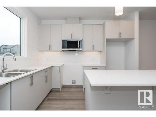 2433 Trumpeter Way, Edmonton, AB - Indoor Photo Showing Kitchen With Double Sink