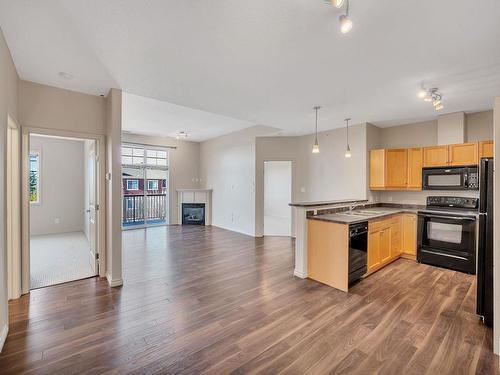 318 2503 Hanna Crescent, Edmonton, AB - Indoor Photo Showing Kitchen With Fireplace