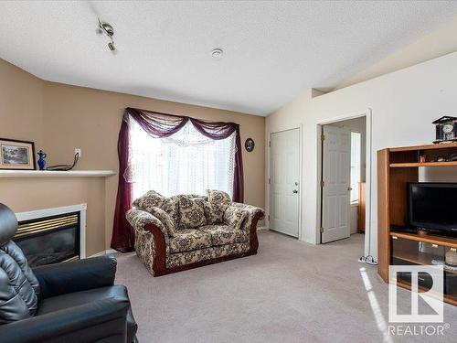 16 4527 55 Avenue, Tofield, AB - Indoor Photo Showing Living Room With Fireplace