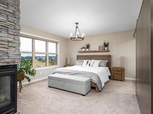 29 Garneau Gate, Spruce Grove, AB - Indoor Photo Showing Bedroom With Fireplace