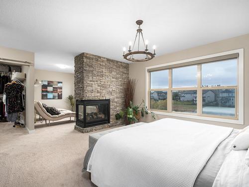 29 Garneau Gate, Spruce Grove, AB - Indoor Photo Showing Bedroom With Fireplace