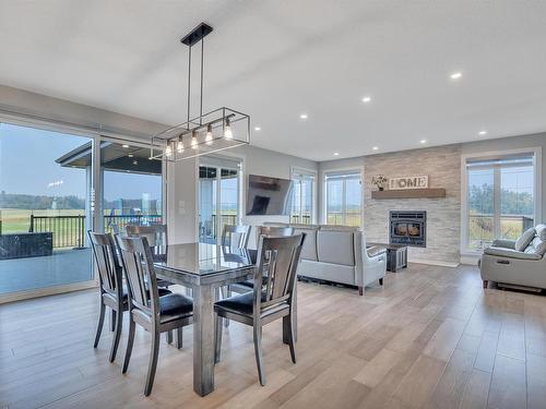 58108 Rge Rd 240, Rural Sturgeon County, AB - Indoor Photo Showing Dining Room With Fireplace