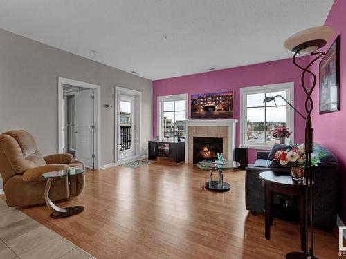 416 160 Magrath Road, Edmonton, AB - Indoor Photo Showing Living Room With Fireplace