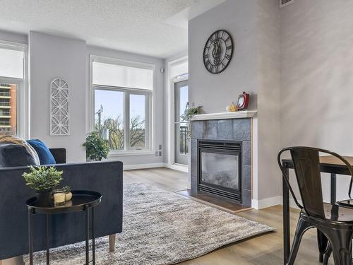 403 9020 Jasper Avenue, Edmonton, AB - Indoor Photo Showing Living Room With Fireplace