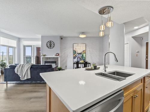 403 9020 Jasper Avenue, Edmonton, AB - Indoor Photo Showing Kitchen With Fireplace With Double Sink