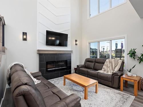 398 Bluff Cove, Leduc, AB - Indoor Photo Showing Living Room With Fireplace