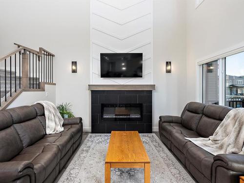 398 Bluff Cove, Leduc, AB - Indoor Photo Showing Living Room With Fireplace