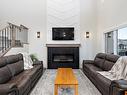 398 Bluff Cove, Leduc, AB  - Indoor Photo Showing Living Room With Fireplace 