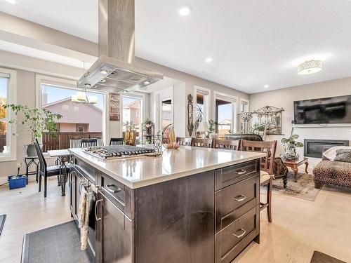 4 Lakeshore Cove, Beaumont, AB - Indoor Photo Showing Kitchen With Fireplace