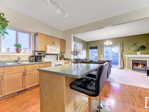 9011 166 Avenue, Edmonton, AB - Indoor Photo Showing Kitchen With Fireplace With Double Sink