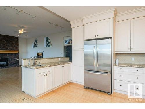 220 Grandisle Point, Edmonton, AB - Indoor Photo Showing Kitchen With Fireplace With Double Sink