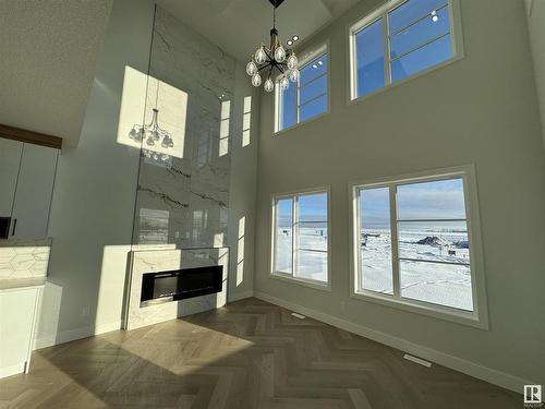 25 Baker Street, Ardrossan, AB - Indoor Photo Showing Other Room With Fireplace