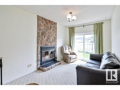 4507 51 Street, Millet, AB - Indoor Photo Showing Living Room With Fireplace