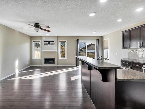 5325 15 Avenue, Edmonton, AB - Indoor Photo Showing Kitchen With Fireplace