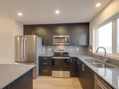 2462 Trumpeter Way, Edmonton, AB - Indoor Photo Showing Kitchen With Stainless Steel Kitchen With Double Sink With Upgraded Kitchen