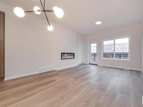 175 Stonehouse Way, Leduc, AB - Indoor Photo Showing Other Room With Fireplace