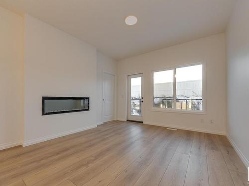 179 Stonehouse Way, Leduc, AB - Indoor Photo Showing Living Room With Fireplace