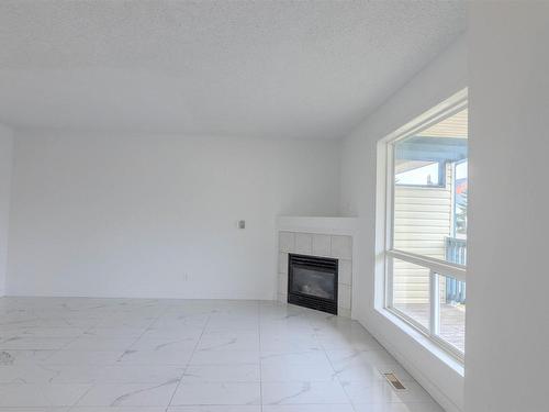 88 10909 106 Street, Edmonton, AB - Indoor Photo Showing Living Room With Fireplace