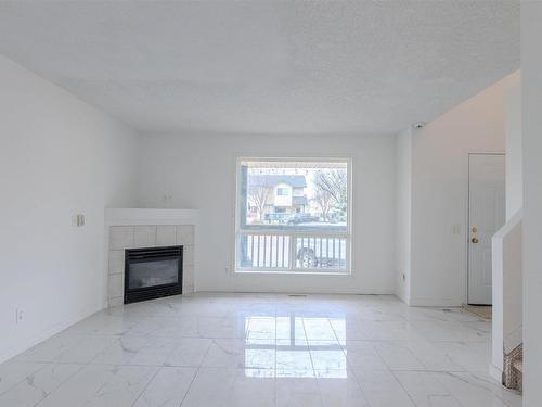 88 10909 106 Street, Edmonton, AB - Indoor Photo Showing Living Room With Fireplace