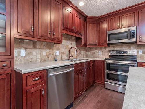 Edmonton, AB - Indoor Photo Showing Kitchen With Stainless Steel Kitchen With Double Sink