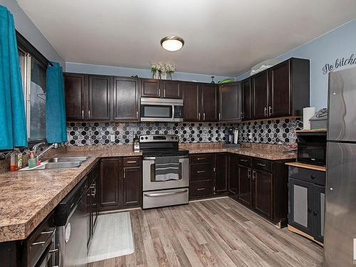 23 Bella Coola Drive, Leduc, AB - Indoor Photo Showing Kitchen With Double Sink