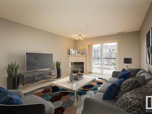 220 2098 Blackmud Creek Drive, Edmonton, AB - Indoor Photo Showing Living Room With Fireplace