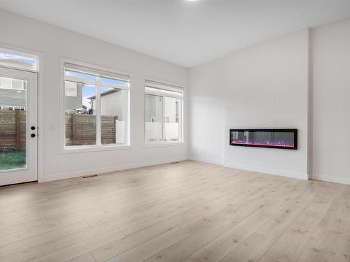 Edmonton, AB - Indoor Photo Showing Living Room With Fireplace