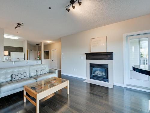 202 10809 Saskatchewan Drive, Edmonton, AB - Indoor Photo Showing Living Room With Fireplace