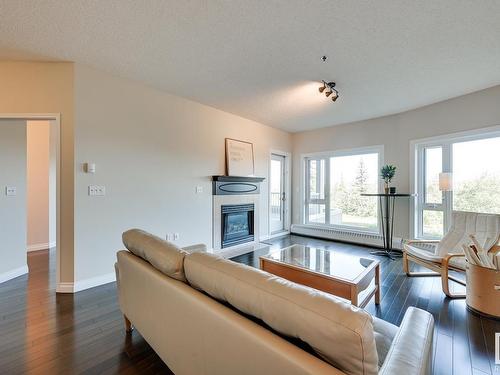 202 10809 Saskatchewan Drive, Edmonton, AB - Indoor Photo Showing Living Room With Fireplace