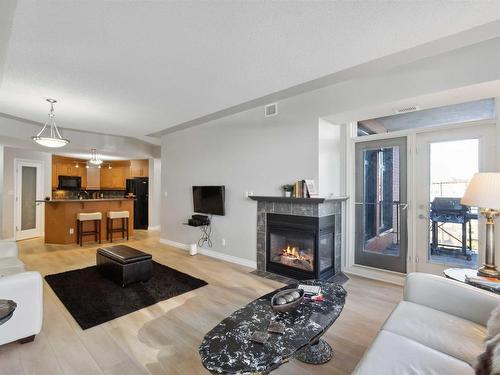 402 9020 Jasper Avenue, Edmonton, AB - Indoor Photo Showing Living Room With Fireplace