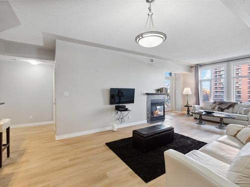 402 9020 Jasper Avenue, Edmonton, AB - Indoor Photo Showing Living Room With Fireplace