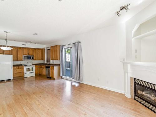 102 10630 78 Avenue, Edmonton, AB - Indoor Photo Showing Other Room With Fireplace