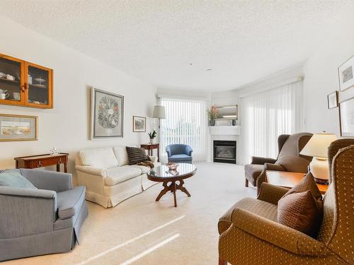 402 182 Haddow Close, Edmonton, AB - Indoor Photo Showing Living Room With Fireplace