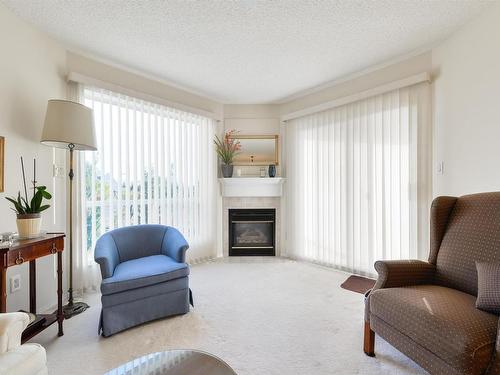 402 182 Haddow Close, Edmonton, AB - Indoor Photo Showing Living Room With Fireplace