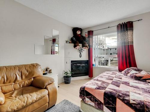 20 1580 Mill Woods Rd E, Edmonton, AB - Indoor Photo Showing Bedroom With Fireplace