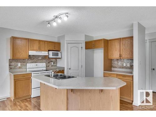 103 Rue Masson, Beaumont, AB - Indoor Photo Showing Kitchen With Double Sink