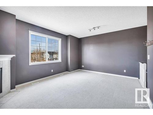 103 Rue Masson, Beaumont, AB - Indoor Photo Showing Other Room With Fireplace