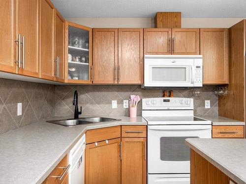 216 11615 Ellerslie Road, Edmonton, AB - Indoor Photo Showing Kitchen With Double Sink