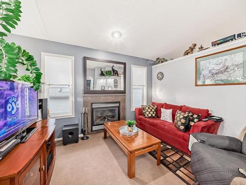 3407 47 Street, Beaumont, AB - Indoor Photo Showing Living Room With Fireplace