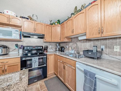 3407 47 Street, Beaumont, AB - Indoor Photo Showing Kitchen With Double Sink