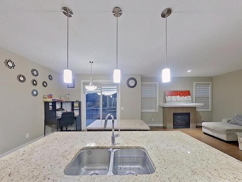 3938 Cherry Cove Sw, Edmonton, AB - Indoor Photo Showing Kitchen With Fireplace With Double Sink